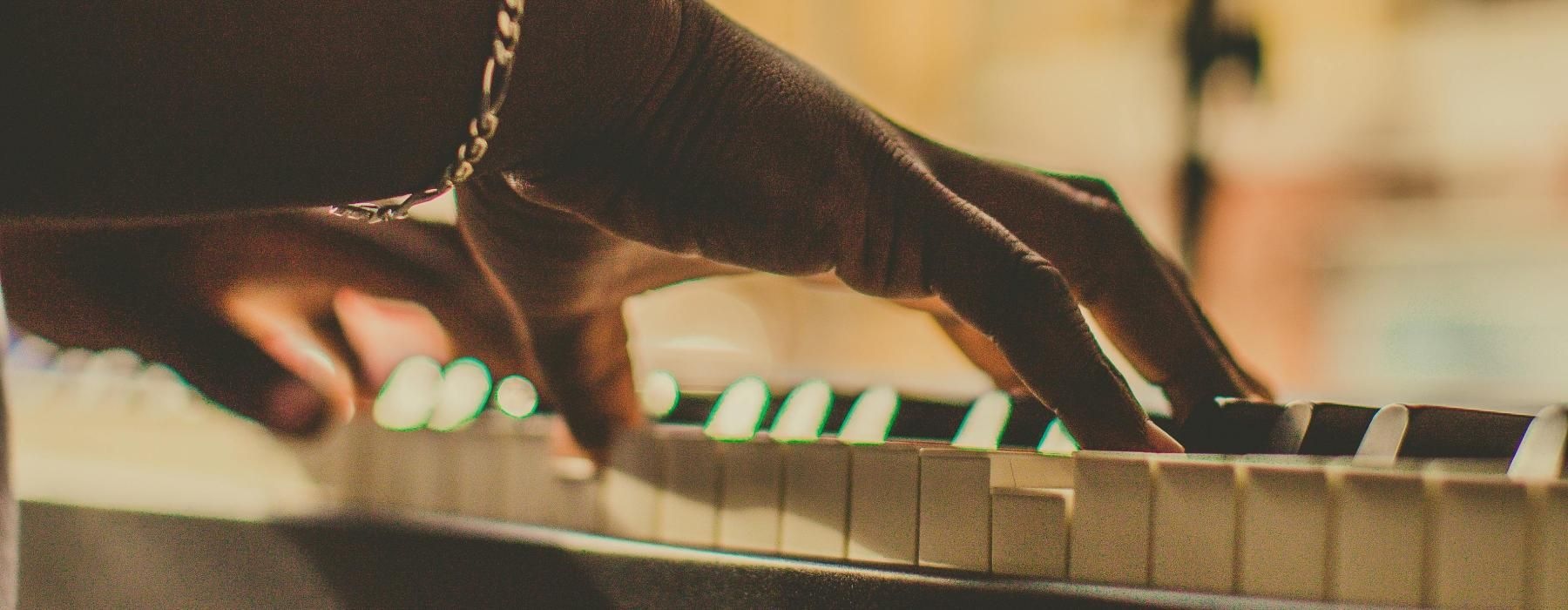 a person playing a piano with a microphone