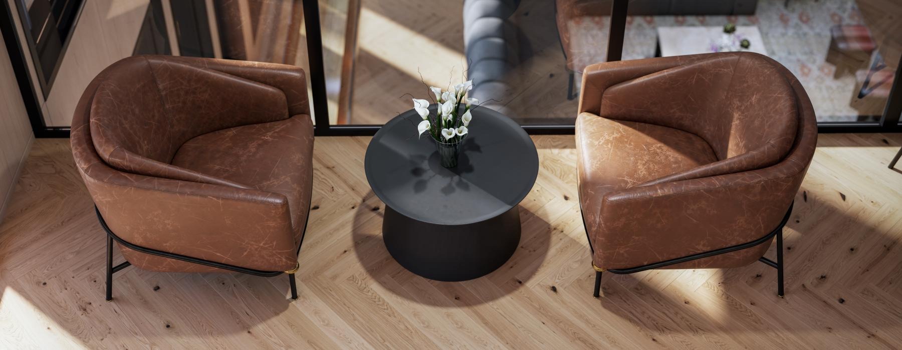 a lounge room with chairs and a plant