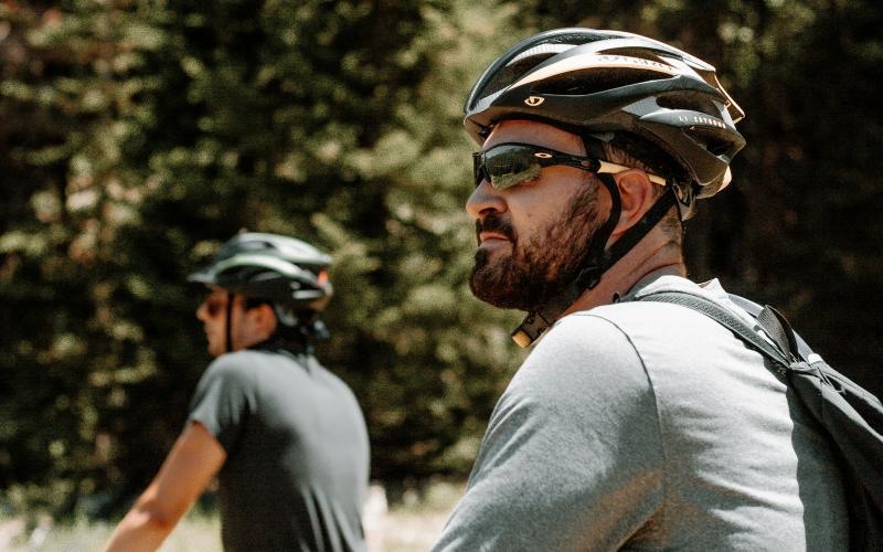 A beautiful community at the heart of all your passions two men on bikes in a field